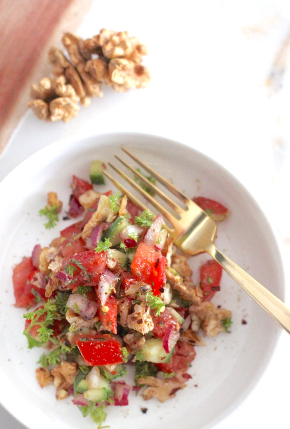 In a small nonstick skillet heat the walnuts until just warm and slightly toasted. Remove from the heat and add into a medium mixing bowl and let cool for 5 minutes. Add all the other ingredients into the bowl with the walnuts and toss until well combined. Chill in the fridge for 30 minutes to allow the flavors to blend and enhance. Spoon mixture into serving bowl and serve. Note: If you cannot find pomegranate molasses, balsamic vinegar can also substitute.